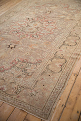 Distressed Kayseri rug border showing dramatic dark arabesques and a faded red spandrel.