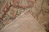 Folded corner of distressed Kayseri carpet revealing worn pile and hand-knotted reverse.