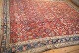 Angled corner view of a vintage Kurdish Hamadan showing the thick wool pile and detailed floral border.