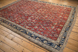 Vintage Kurdish Hamadan rug showing natural color shifts across its cherry red Herati pattern.