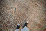 Distressed antique Persian Doroksh carpet's faded Herati field, showing subtle abrashes and muted tones.