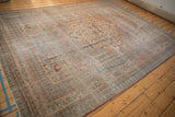 Antique Doroksh carpet's subtle turtle samovar border and distressed field with pale blues and reds.