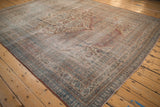Distressed antique Doroksh carpet corner with muted red, blue, and gold turtle samovar border.