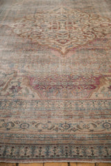 Distressed antique Persian Doroksh carpet's muted Herati and turtle samovar patterns with visible foundation.