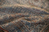 Detail of antique Doroksh carpet showing worn foundation, sky blue, red curvilinear motifs.