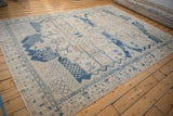 Machine bound edge of the distressed vintage Bakhtiari carpet, with geometric blue border.