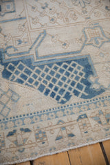 Distressed Bakhtiari carpet detail: dusty sapphire blue lattice design, pale coffee brown motifs, even wear.