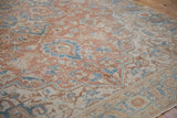 The soft, low-pile texture of a distressed Heriz rug in sandalwood, sky blue, and ivory.