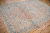 Angled view highlighting the softened sandalwood and sky blue palette of a vintage Heriz carpet.