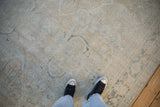 Vintage distressed Mahal carpet, worn pile showing subtle patterns in platinum, ivory, dusty teal.