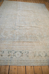 Distressed Mahal rug's main border with dusty teal motifs and worn field texture.