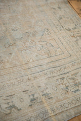 Distressed Mahal carpet showcasing muted beige field with serrated leaves and teal border.