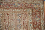 Intricate chestnut border with floral palmettes on a distressed vintage Persian Qom carpet.