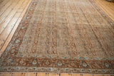 The refined columnar pattern of a distressed Persian rug in rust and dusty sky blue tones.