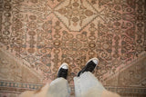 Low pile showing the evenly worn texture and Herati motif of a vintage overdyed Bibikabad carpet.