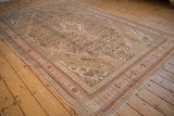 Angled perspective of a vintage distressed Bibikabad rug showing its soft pink and sand palette.