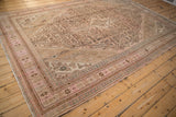 Corner detail of a distressed Persian rug with a stepped spandrel in pink and slate blue.