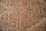 Low, even wear on a vintage Bibikabad carpet showing the knotted Herati pattern in pink and brown.