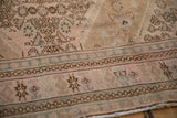 Evenly worn pile of a vintage Bibikabad rug with a dusty blue and chocolate brown border pattern.