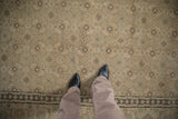 Overhead view of a distressed Tabriz carpet highlighting the low pile texture and Herati design.