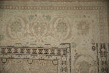Detail of the samovar turtle and Herati main border on a distressed vintage Tabriz carpet.