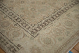 A detailed corner view of the distressed Tabriz carpet's samovar turtle border and worn pile.