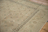 Detailed view of the distressed Tabriz carpet's Herati field meeting its samovar turtle border.