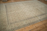 Angled view of a distressed Tabriz carpet showing the samovar turtle border and tone-on-tone Herati field.