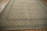 A detailed samovar turtle border frames the Herati field of this vintage distressed Persian Tabriz carpet.