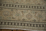 Close-up of the samovar turtle and Herati border on a distressed vintage Tabriz carpet.