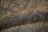 A soft fold showing the even wear and textural pile of a distressed Persian Mahal carpet.