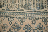 Close-up on a Joshegan carpet's knot heads, showing faded sapphire blue and beige floral designs.