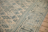 Low, even pile of a distressed Joshegan rug showing dusty teal and sapphire blue florals.