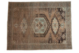 A vintage distressed overdyed Persian Veece carpet with a geometric medallion in sand, brown, and powder blue.