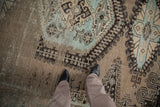 Distressed pile of a vintage Veece carpet showing wear, with sand, brown, and powder blue patterns.