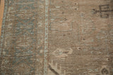 Close-up of the distressed, low-pile texture showing mostly even wear down to the knot heads.