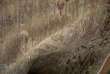 Detailed view of the vintage Veece carpet's low pile with visible hand-knotted foundation.