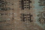 Close-up of the distressed, low-pile texture showing visible knot heads and foundation.