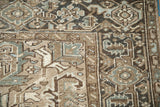 Distressed vintage Heriz carpet corner, showing geometric leaves, palmettes, and soft abrashes.