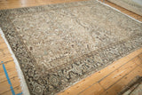 Distressed vintage Heriz rug detail: geometric border, turtle motifs, palmettes, muted beige and brown.