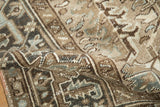 Distressed vintage Heriz carpet pile close-up, showcasing geometric palmettes and soft abrashes.