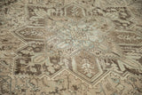 The low, distressed pile on the geometric quatrefoil medallion of a vintage Mehrivan carpet.