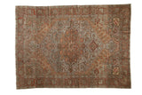 Distressed Bakhtiari rug with central medallion, flowing floral designs, and aged copper, olive tones.