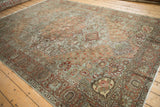 Vintage Distressed Bakhtiari rug corner with faded floral spandrel and terracotta palmette border.