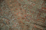 Distressed Bakhtiari rug detail shows worn pile of dusty olive and terracotta floral arabesques.