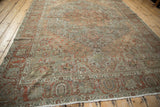 Vintage Bakhtiari rug corner with stepped spandrel, palmette border, and dusty terracotta, olive tones.