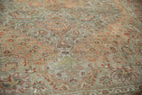 Distressed pile texture of a vintage Bakhtiari carpet, showing faded floral arabesques and stepped contours.