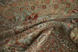 Close-up of distressed Bakhtiari carpet pile, revealing soft copper, blush, and olive arabesque motifs.