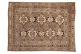 Vintage distressed Kars carpet with geometric medallions in earthy charcoal, silver, and ivory tones.