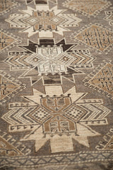 Angled perspective of the distressed Kars carpet's low pile and geometric hook-and-latch motifs.